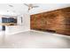 Open-concept living room featuring wood accent wall and kitchen at 2125 Shackley Pl, Apopka, FL 32703