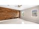 Living room with wood accent wall and light tile floors at 2125 Shackley Pl, Apopka, FL 32703
