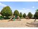 A colorful playground with slides and climbing structures, surrounded by lush green trees on a wood chip base at 2125 Shackley Pl, Apopka, FL 32703