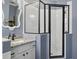 Bathroom featuring a black-framed glass shower and granite countertops at 2215 Guiana Plum Dr, Orlando, FL 32828