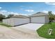 Detached two car garage with a well manicured lawn, driveway, and privacy fence at 2215 Guiana Plum Dr, Orlando, FL 32828