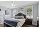 Serene bedroom with a plush bed, ceiling fan, and natural light at 2215 Guiana Plum Dr, Orlando, FL 32828