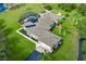 Stunning aerial view of a spacious single-story home with a screened pool, solar panels, and lush landscaping at 2326 Florida Ave, Oviedo, FL 32765