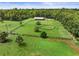 An aerial view showcases a beautiful property with lush green pastures and surrounding trees at 2326 Florida Ave, Oviedo, FL 32765