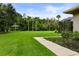 Expansive backyard featuring lush green grass and a gazebo near the pond in a private setting at 2326 Florida Ave, Oviedo, FL 32765