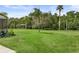 Lush backyard with gazebo and mature landscaping offering a serene view of the adjacent pond at 2326 Florida Ave, Oviedo, FL 32765