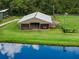 A well maintained barn sits next to a pond with well manicured grassy areas at 2326 Florida Ave, Oviedo, FL 32765