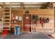 Indoor barn area with wooded wall, feed room door, and mounted tack and accessories at 2326 Florida Ave, Oviedo, FL 32765