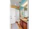 Well lit bathroom showcases granite vanity, tile flooring, and shower with white curtain at 2326 Florida Ave, Oviedo, FL 32765