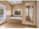 A relaxing soaking tub and glass enclosed shower are featured in this bathroom at 2326 Florida Ave, Oviedo, FL 32765