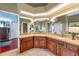 A wide view of the main bath with large vanity, tiled floor, and multiple mirrors at 2326 Florida Ave, Oviedo, FL 32765