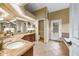 The large bathroom features granite countertops, tile floor, and access to a shower and soaking tub at 2326 Florida Ave, Oviedo, FL 32765