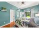 Comfortable bedroom boasts a tropical-themed bedspread, bright natural light, and hardwood floors at 2326 Florida Ave, Oviedo, FL 32765