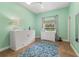 Bright bedroom with mint green walls features a tile floor and two dressers at 2326 Florida Ave, Oviedo, FL 32765