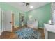 Bright bedroom features a window with decorative curtains and a blue patterned rug over tile flooring at 2326 Florida Ave, Oviedo, FL 32765