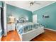 Charming bedroom displays a tropical-themed bedspread, nightstands, and white trim at 2326 Florida Ave, Oviedo, FL 32765