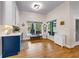Breakfast nook with large windows overlooking the pool area, custom cabinets, and wood flooring at 2326 Florida Ave, Oviedo, FL 32765