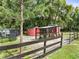 A chicken coop and storage shed are located inside a split rail fence at 2326 Florida Ave, Oviedo, FL 32765