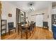 Elegant dining room with a modern light fixture, stylish curtains, and a barn door accent at 2326 Florida Ave, Oviedo, FL 32765