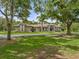 Charming home featuring mature trees, a circular driveway, and a beautifully landscaped front yard at 2326 Florida Ave, Oviedo, FL 32765
