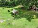 A backyard greenhouse is surrounded by a large lawn and trees at 2326 Florida Ave, Oviedo, FL 32765