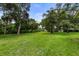 Expansive backyard with well-maintained lawn and beautiful trees, offering privacy and serenity at 2326 Florida Ave, Oviedo, FL 32765