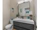 Stylish half bathroom with a modern vanity, contemporary mirror, and nautical decor at 2326 Florida Ave, Oviedo, FL 32765