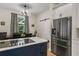 This kitchen showcases a modern island, stainless fridge, and bright dining area with unique light fixture at 2326 Florida Ave, Oviedo, FL 32765