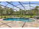 Screened-in pool area featuring a luxurious pool and spa, with a beautiful backyard view at 2326 Florida Ave, Oviedo, FL 32765