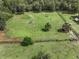 Aerial view of a large fenced property featuring a lush green field and scattered trees at 2326 Florida Ave, Oviedo, FL 32765