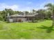 A rear exterior shows a patio, solar panels, and well manicured lawn at 2326 Florida Ave, Oviedo, FL 32765