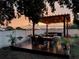 Outdoor dining and seating area with a pergola and strung lights, perfect for evening gatherings at 2349 Plantation Oak Dr, Orlando, FL 32824