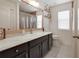 Beautiful bathroom featuring a wood framed mirror, decorative shelving, and modern vanity with marble countertop at 2349 Plantation Oak Dr, Orlando, FL 32824