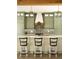 Stunning kitchen with white countertops, sage cabinets, decorative backsplash, and modern lighting at 2349 Plantation Oak Dr, Orlando, FL 32824