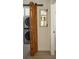 Convenient laundry room with stacked washer and dryer units and a rustic sliding barn door at 2349 Plantation Oak Dr, Orlando, FL 32824