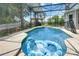 Inviting screened-in pool with in-pool float and seating area, perfect for relaxation and entertainment at 2349 Plantation Oak Dr, Orlando, FL 32824