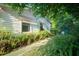 Side view of a home with awning covered windows and lush ferns lining the walkway at 2361 Kimberly Dr, Deltona, FL 32738