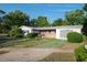 Charming single-story home with a well-maintained lawn, front shrubs and a brick front entry at 2361 Kimberly Dr, Deltona, FL 32738