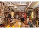 Cluttered garage filled with numerous items and decorative wall hangings at 2361 Kimberly Dr, Deltona, FL 32738
