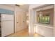 View of kitchen with blue cabinets, orange countertops, vintage refrigerator, and access to other rooms at 2361 Kimberly Dr, Deltona, FL 32738