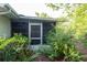 View of a screened lanai surrounded by lush greenery, offering a private outdoor space at 2361 Kimberly Dr, Deltona, FL 32738
