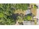 Aerial view of a property showcasing a large backyard with mature trees and surrounding neighborhood at 2409 Garbelia Ave, Orlando, FL 32817