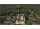 Aerial shot of property highlighting yard space, trees and surrounding neighborhood, outlined in white at 2409 Garbelia Ave, Orlando, FL 32817