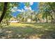 Spacious backyard surrounded by mature trees, offering shade and privacy at 2409 Garbelia Ave, Orlando, FL 32817