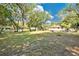 Large backyard features mature trees and a well-maintained lawn, creating a serene outdoor space at 2409 Garbelia Ave, Orlando, FL 32817