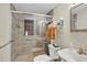 Bathroom featuring a tiled shower with glass door, modern fixtures, and neutral color palette at 2409 Garbelia Ave, Orlando, FL 32817