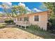 Cozy single story home with front porch and lush, green lawn creates inviting curb appeal at 2409 Garbelia Ave, Orlando, FL 32817