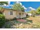 Inviting single story home featuring a quaint porch and a spacious yard with mature landscaping at 2409 Garbelia Ave, Orlando, FL 32817