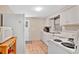 Functional kitchen with white appliances and tile floors awaits your personal touch at 2409 Garbelia Ave, Orlando, FL 32817