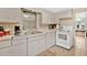 Practical kitchen with white cabinets and appliances offers a clean and functional space for cooking at 2409 Garbelia Ave, Orlando, FL 32817